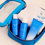 A bright blue zippered toiletry bag opened on a light beige background, containing three Sea Solu Moisture Melts bottles and a white textured towel.